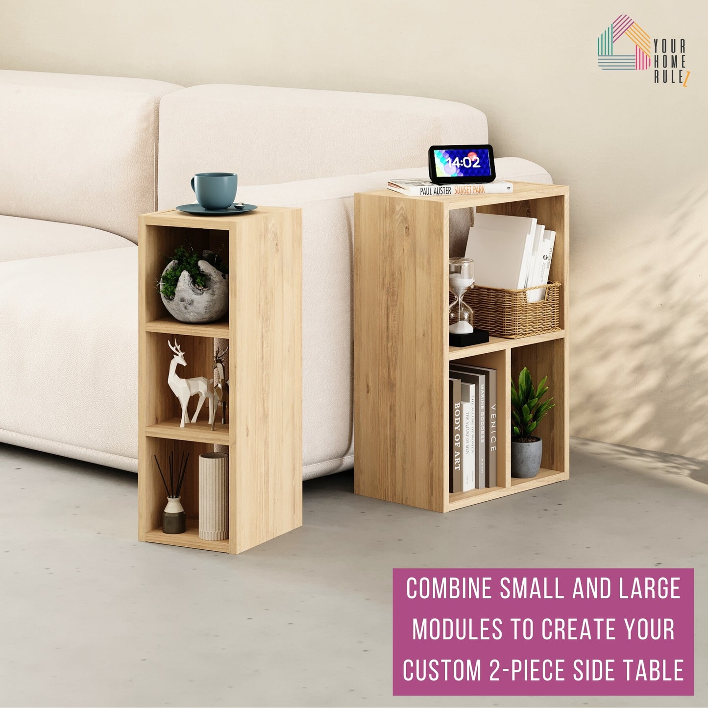 Two-piece side table setup using one small and one large wood-effect shelving module placed next to a cream sofa. The units are styled with books, decorative items, a plant, a digital clock, and a cup. Text at the bottom reads: 'Combine small and large modules to create your custom 2-piece side table.' The 'Your Home Rulez' logo is visible in the top right corner