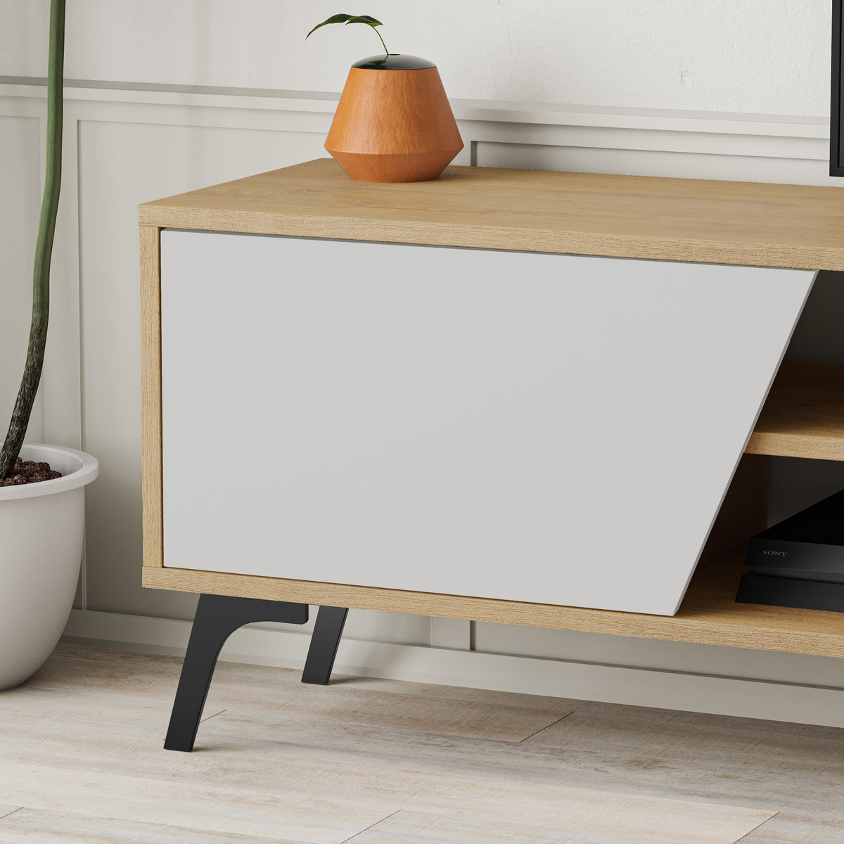 Modern TV unit with metal legs, closed cabinets and open shelves, ideal for media storage in contemporary living rooms