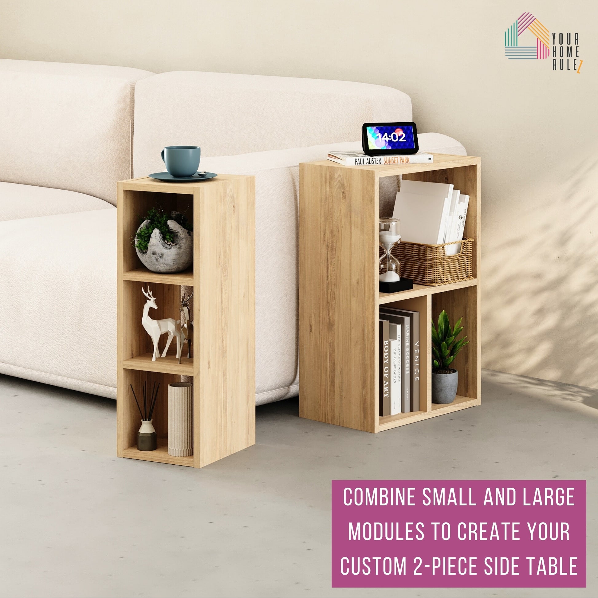 Two-piece side table setup using one small and one large wood-effect shelving module placed next to a cream sofa. The units are styled with books, decorative items, a plant, a digital clock, and a cup. Text at the bottom reads: 'Combine small and large modules to create your custom 2-piece side table.' The 'Your Home Rulez' logo is visible in the top right corner