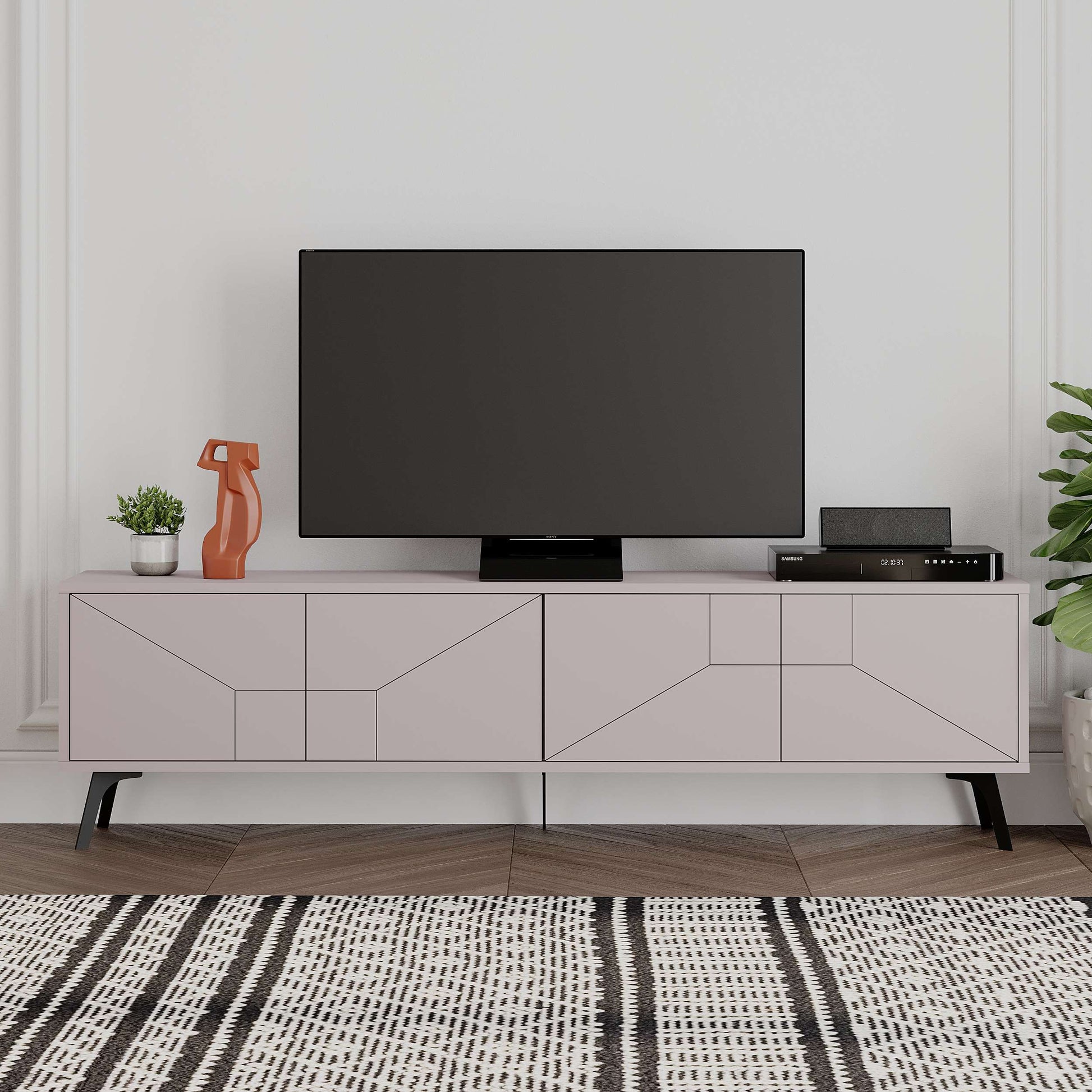 Modern TV stand with geometric pattern doors, raised metal legs, and concealed media storage.
